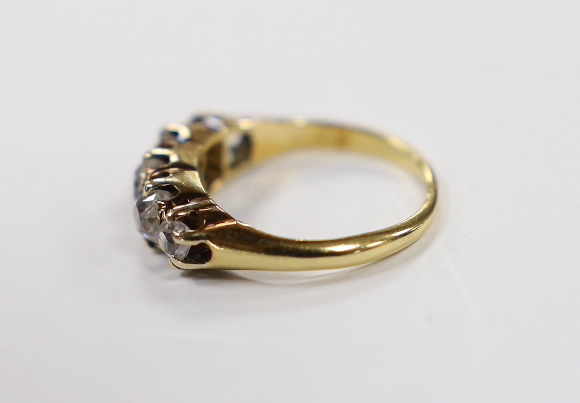 A yellow metal and graduated five stone diamond set half hoop ring, size J, gross weight 3.5 grams (a.f.).